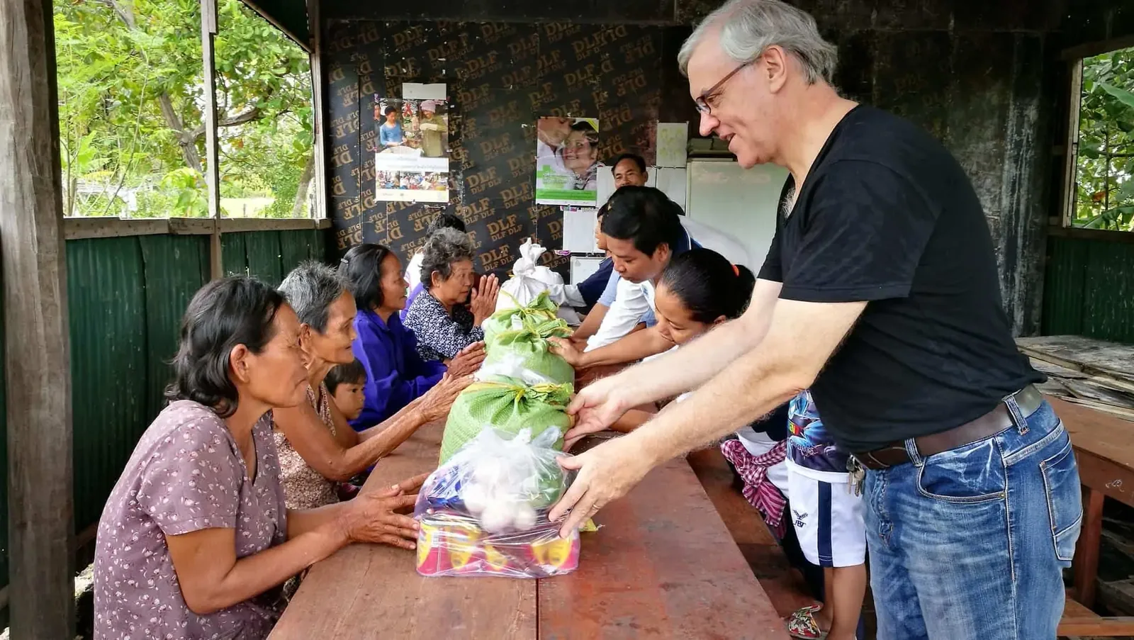 Paul giving food to several of the elderly at the New Day New Life Community Centre in Kampong Chhnang Province in Cambodia