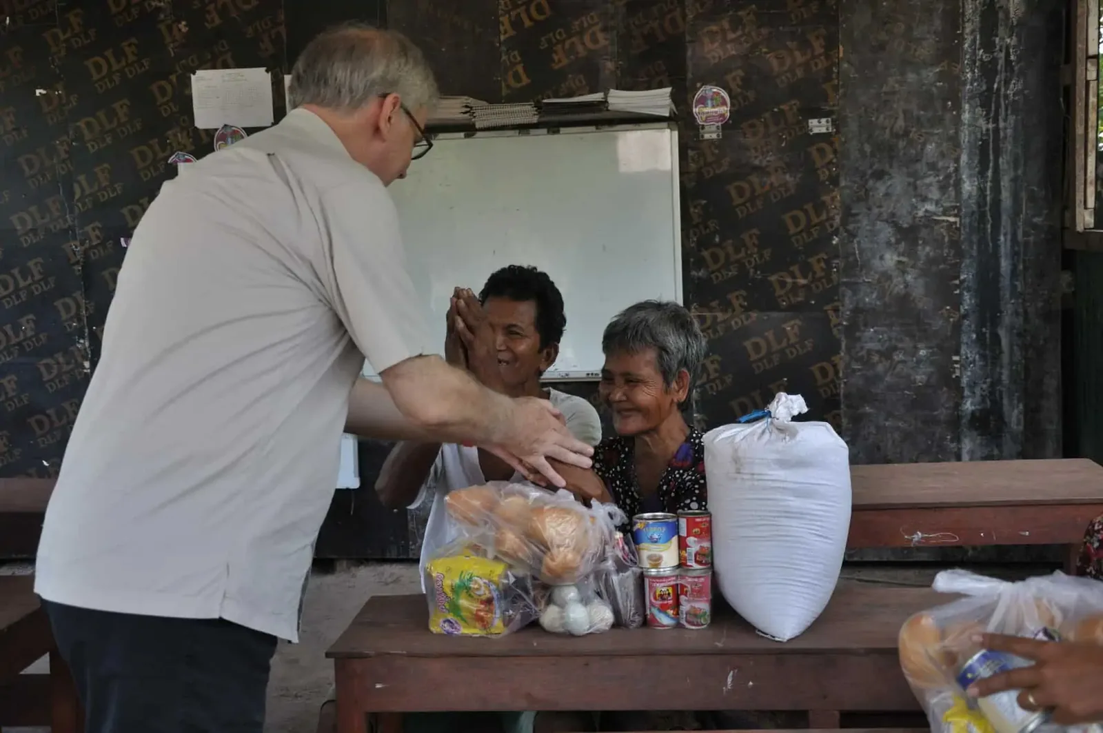 Paul Hughes giving food to one of the elderly in Kampong Chhnang Province in Cambodia