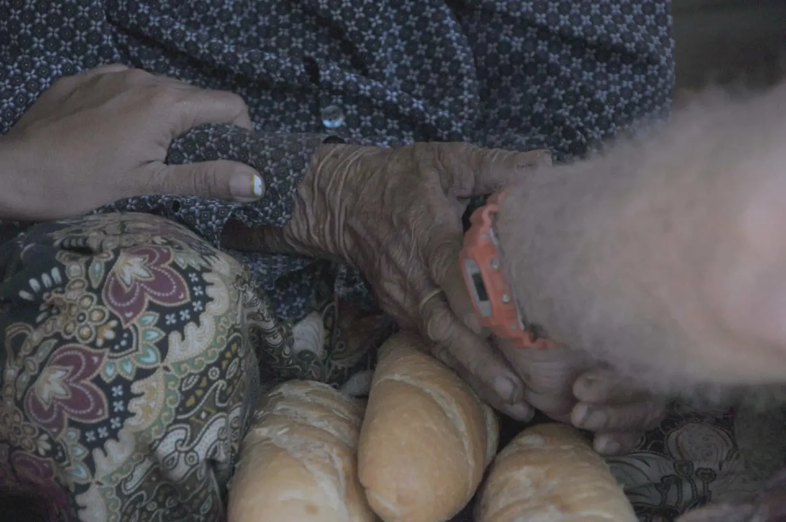 Paul Hughes praying with one of the elderly after giving them some bread.