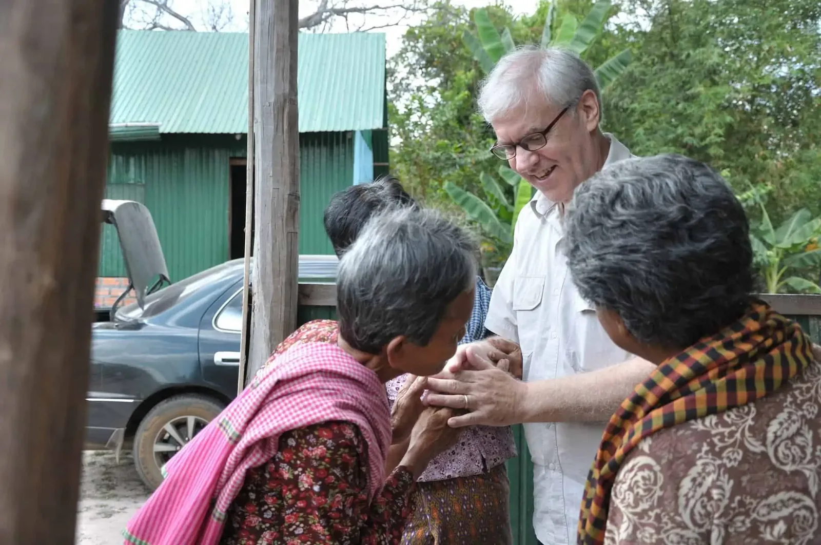 Paul praying and talking to some of the elderly at the NDNL Community Centre