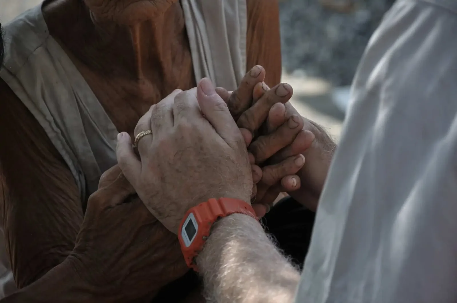 Paul praying with one of the elderly.